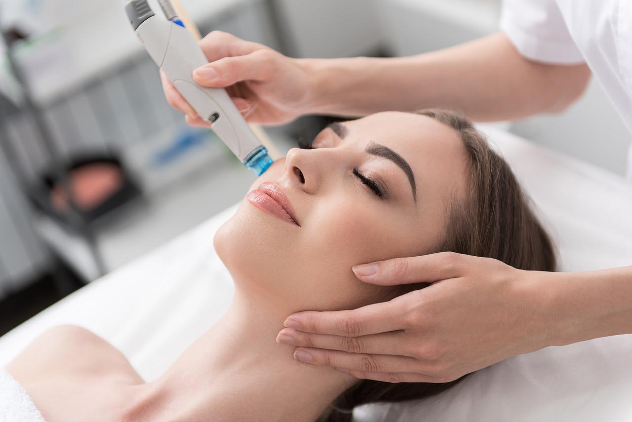 Close up on a plate of mashed potatoes, topped with baked pork chops with cream of mushroom soup, and a side of green beans.