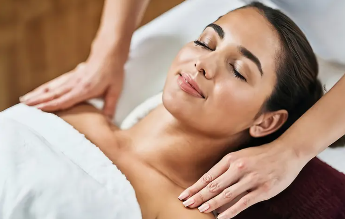 Close up on a plate of mashed potatoes, topped with baked pork chops with cream of mushroom soup, and a side of green beans.