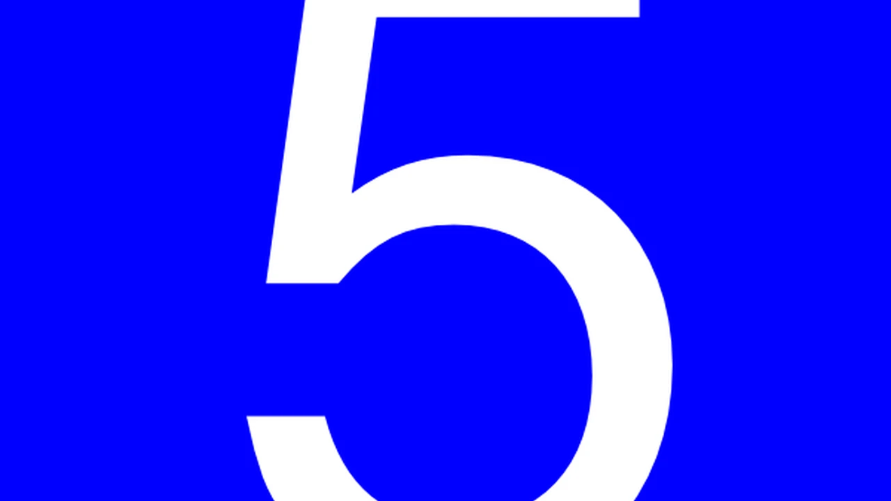 Close up on a plate of mashed potatoes, topped with baked pork chops with cream of mushroom soup, and a side of green beans.