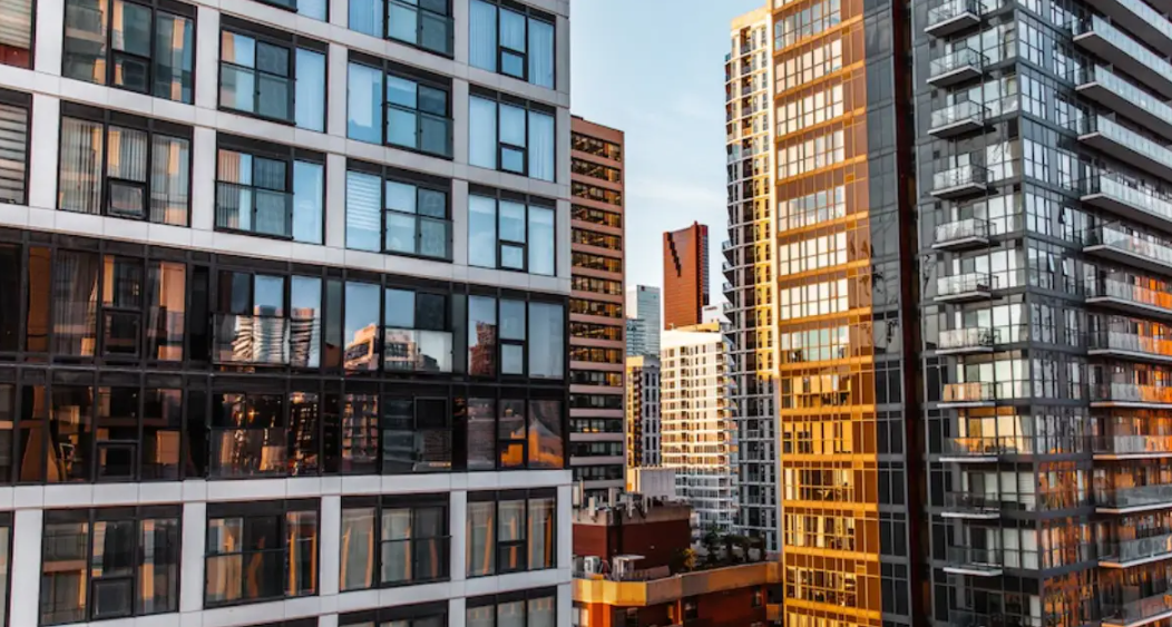 Close up on a plate of mashed potatoes, topped with baked pork chops with cream of mushroom soup, and a side of green beans.