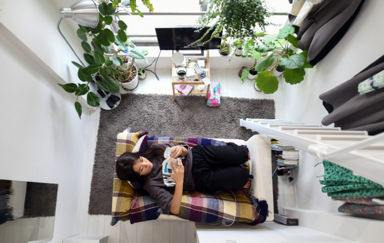 Close up on a plate of mashed potatoes, topped with baked pork chops with cream of mushroom soup, and a side of green beans.