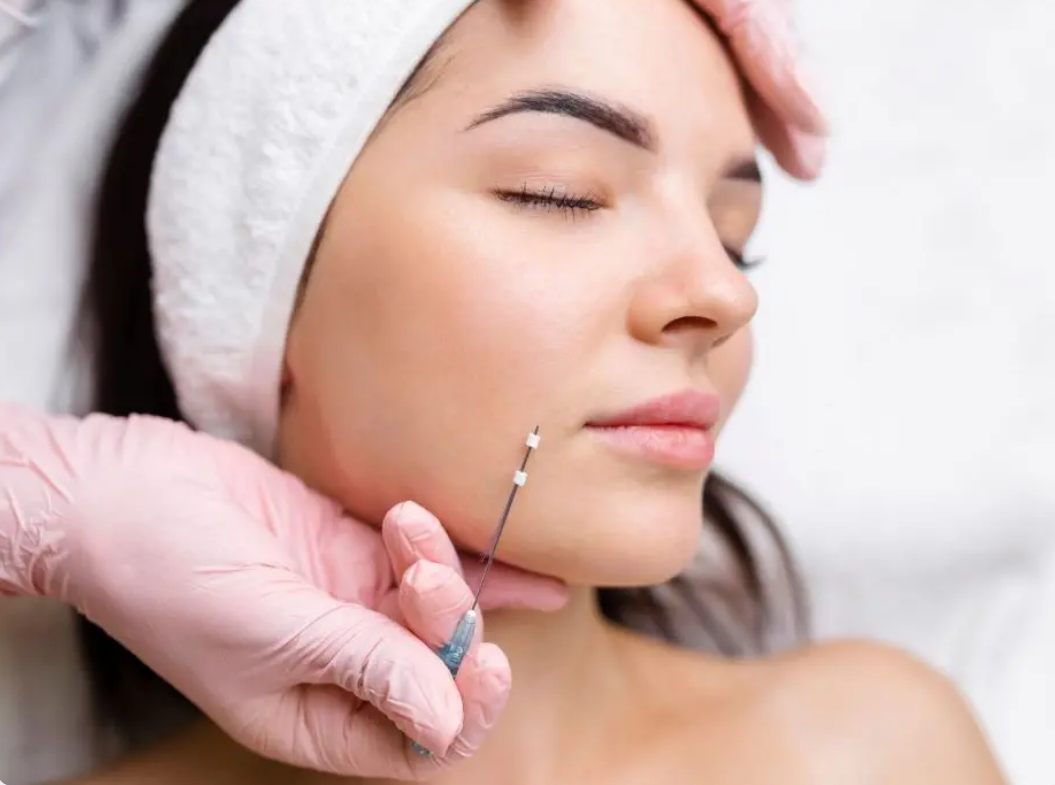 Close up on a plate of mashed potatoes, topped with baked pork chops with cream of mushroom soup, and a side of green beans.